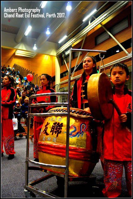A group of people are playing drums at a chinese rest eid festival