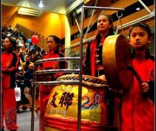 A group of people playing drums in front of a crowd