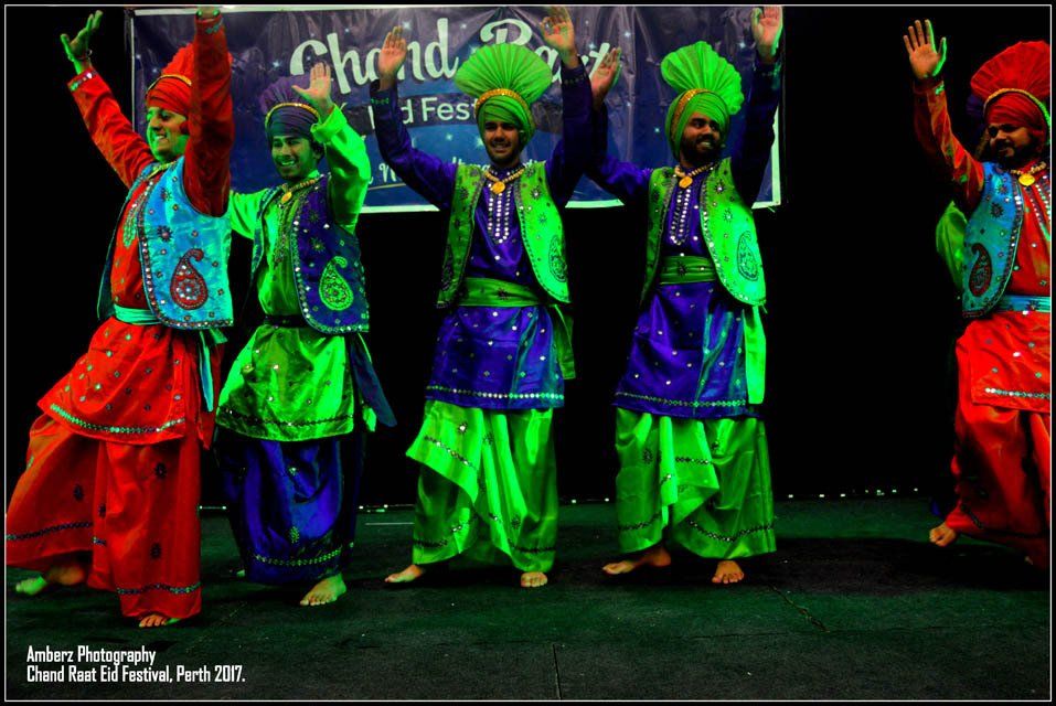 A group of people are dancing in front of a sign that says chrid