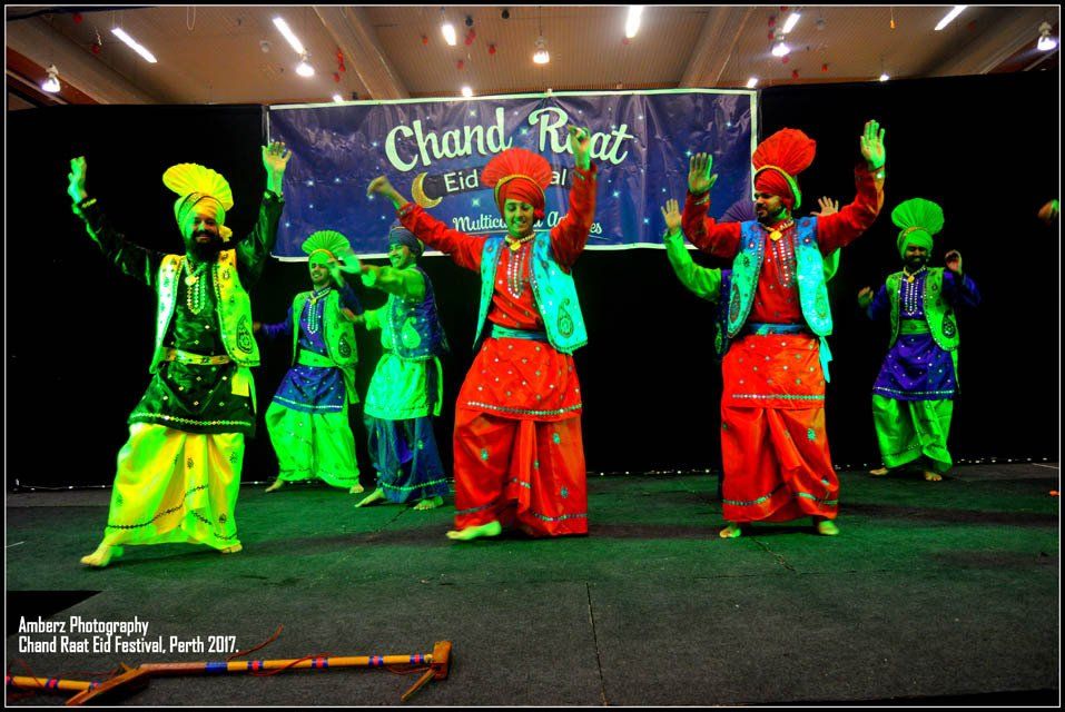 A group of people are dancing in front of a banner that says chand rajat