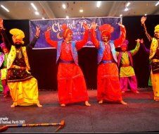 A group of people are dancing in front of a sign that says grand rest
