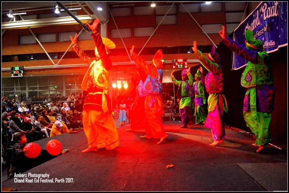 A group of people are dancing in front of a sign that says grand royal