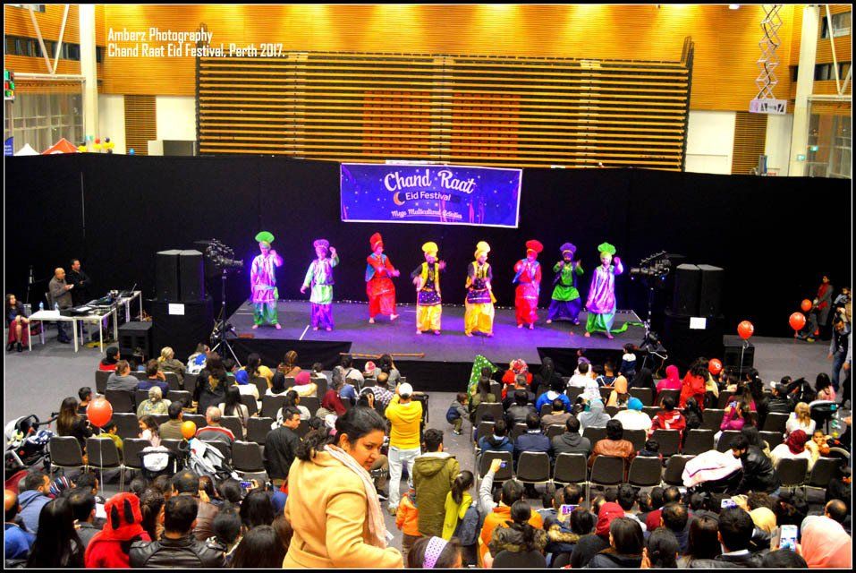 A group of people are standing on a stage in front of a sign that says create your college