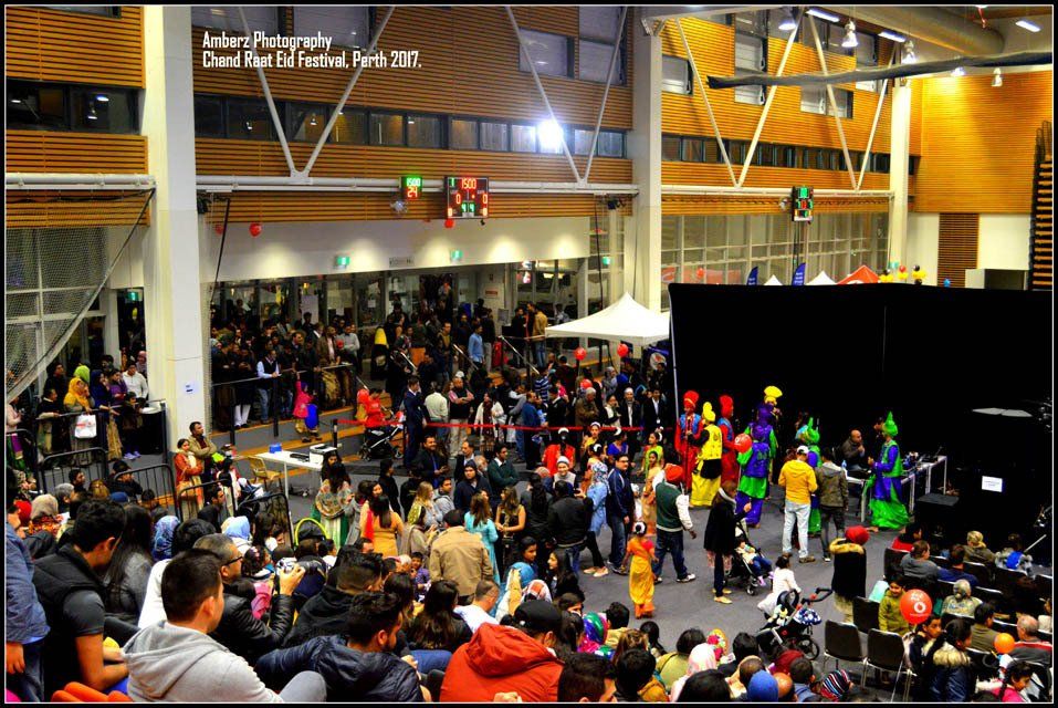 A large crowd of people are gathered in a large room with the date february 27 on the bottom