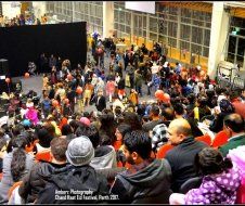 A large crowd of people are gathered in front of a stage