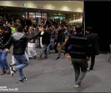 A group of people are dancing in a room.