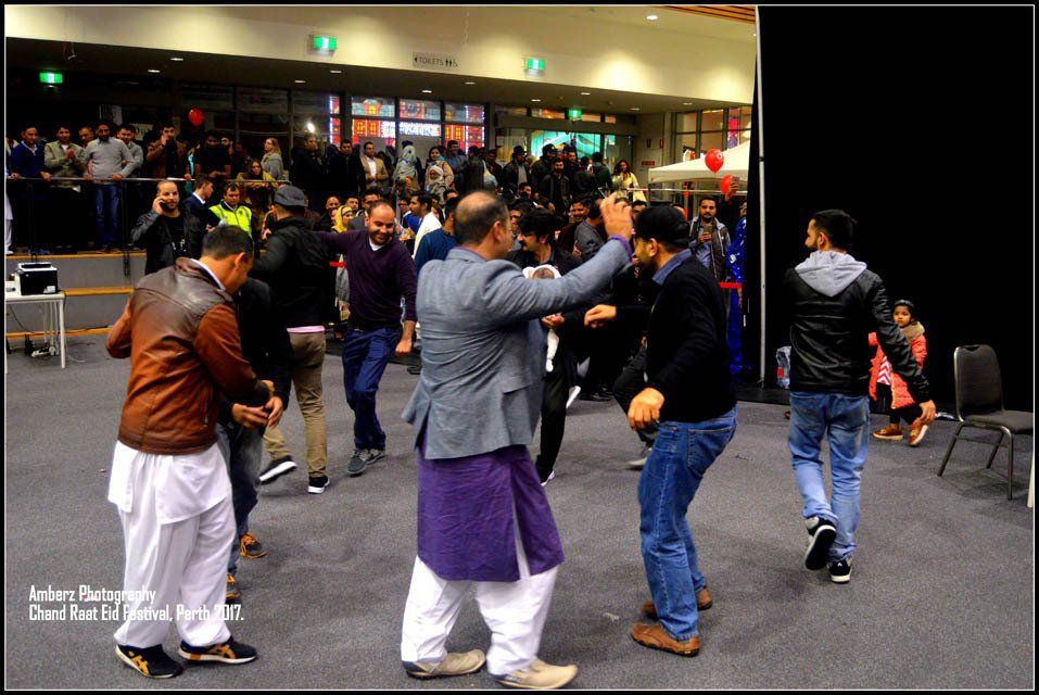 A group of men are dancing together in a room