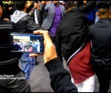 A person is taking a picture of a crowd with a cell phone