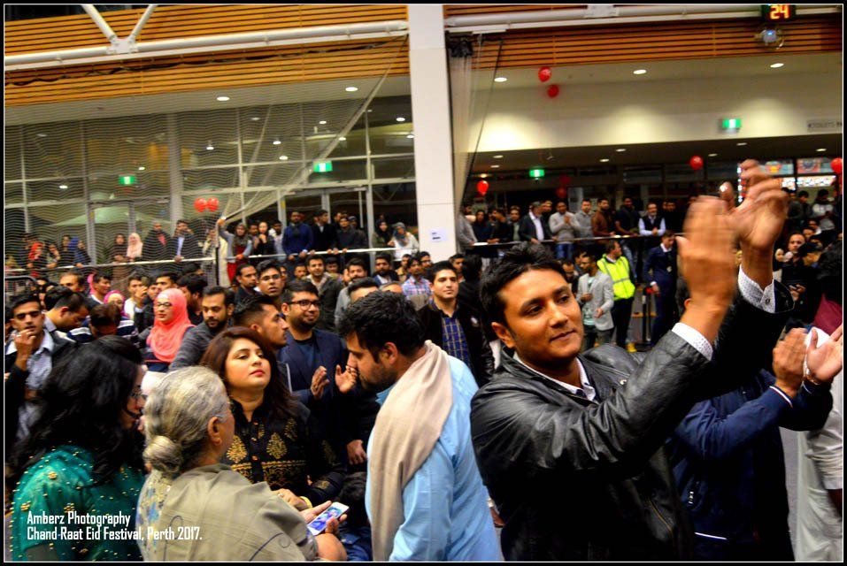 A man is taking a picture of a crowd of people.