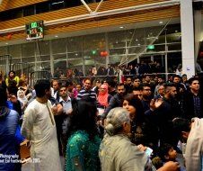 A large group of people are standing in front of a building.