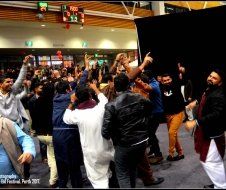 A large group of people are dancing in a room.
