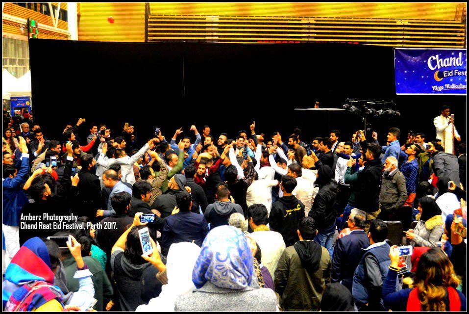 A crowd of people are gathered in front of a sign that says classic coffee