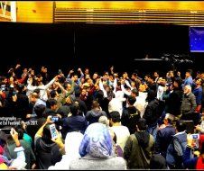 A large group of people are gathered in a room.