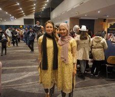 Two women are standing next to each other in a room.