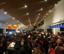 A large crowd of people are gathered in a large room.