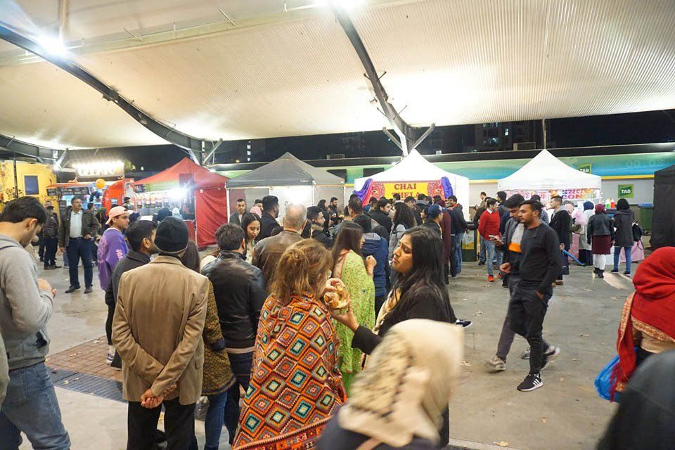 A large group of people are standing in a crowded area.