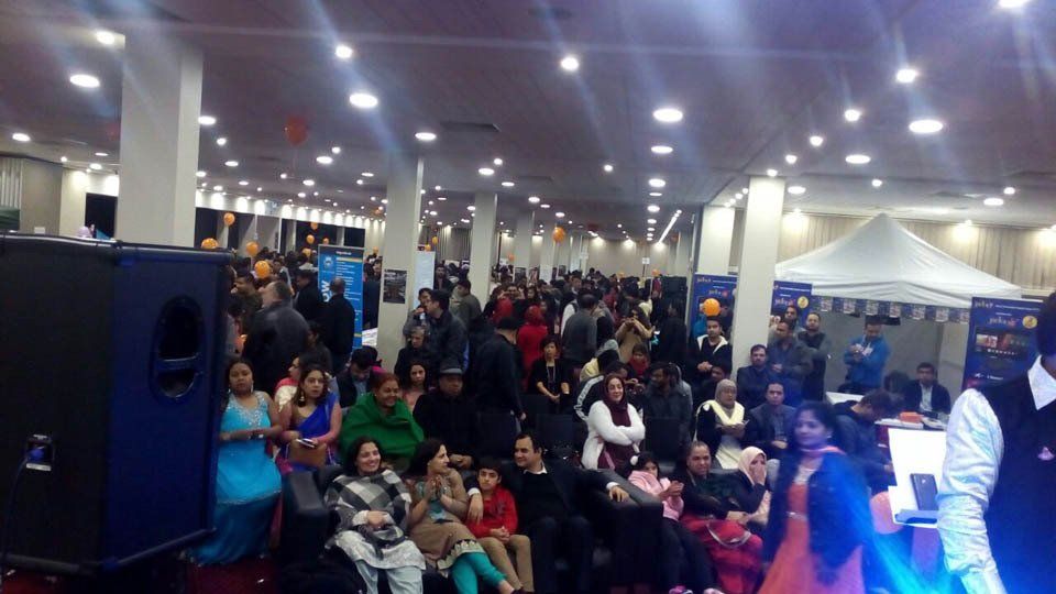 A large group of people are sitting in a large room.