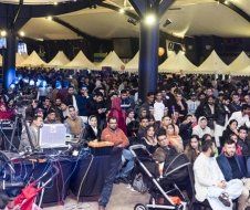A large group of people are sitting in a large room.