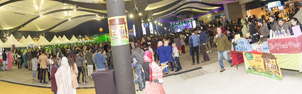 A large group of people are standing in a large room.