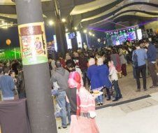 A large group of people are standing in a room.