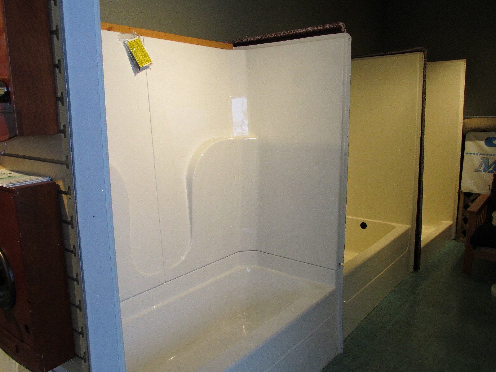 A white bathtub with a yellow tag on it