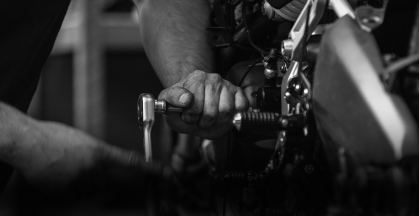 Technician performing maintenance on vehicle | DeMartile Auto Care & Tires