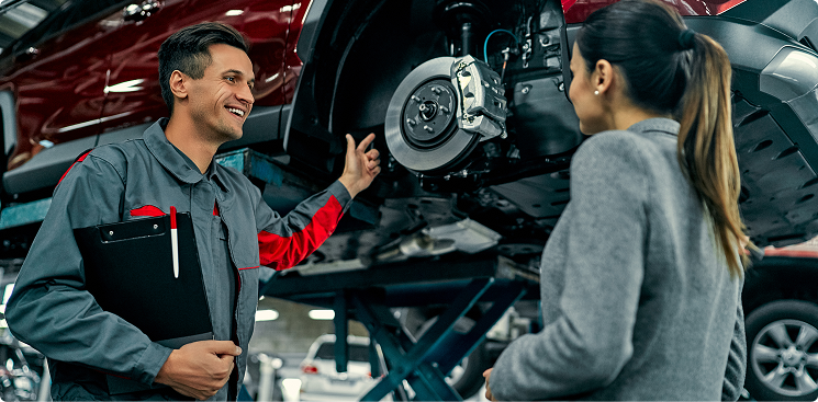 Technician discussing brake repair to customer | DeMartile Auto Care & Tires