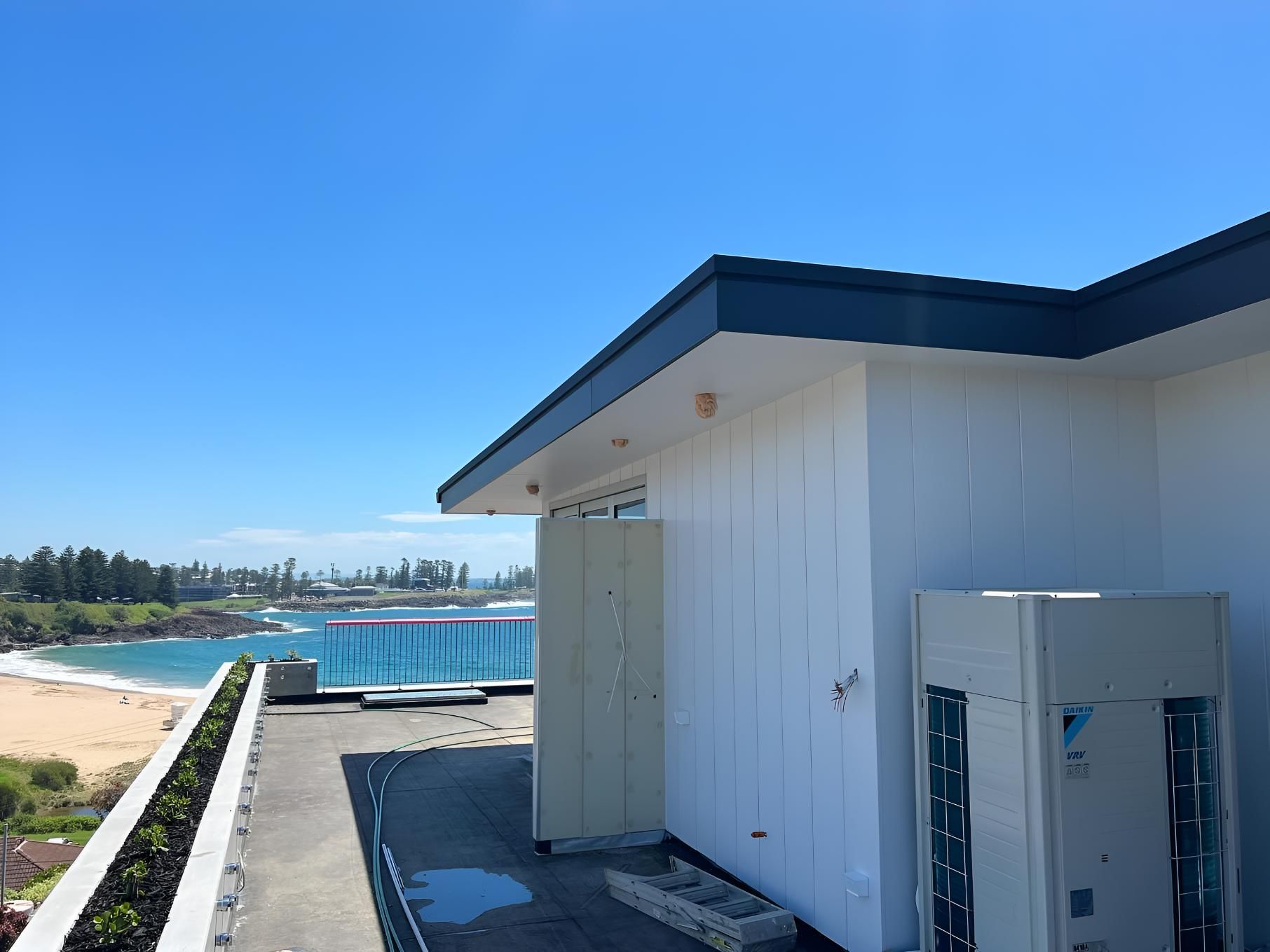 Fan is Sitting on the Side of a Building Next — Kiama Air Conditioning in Albion Park Rail, NSW