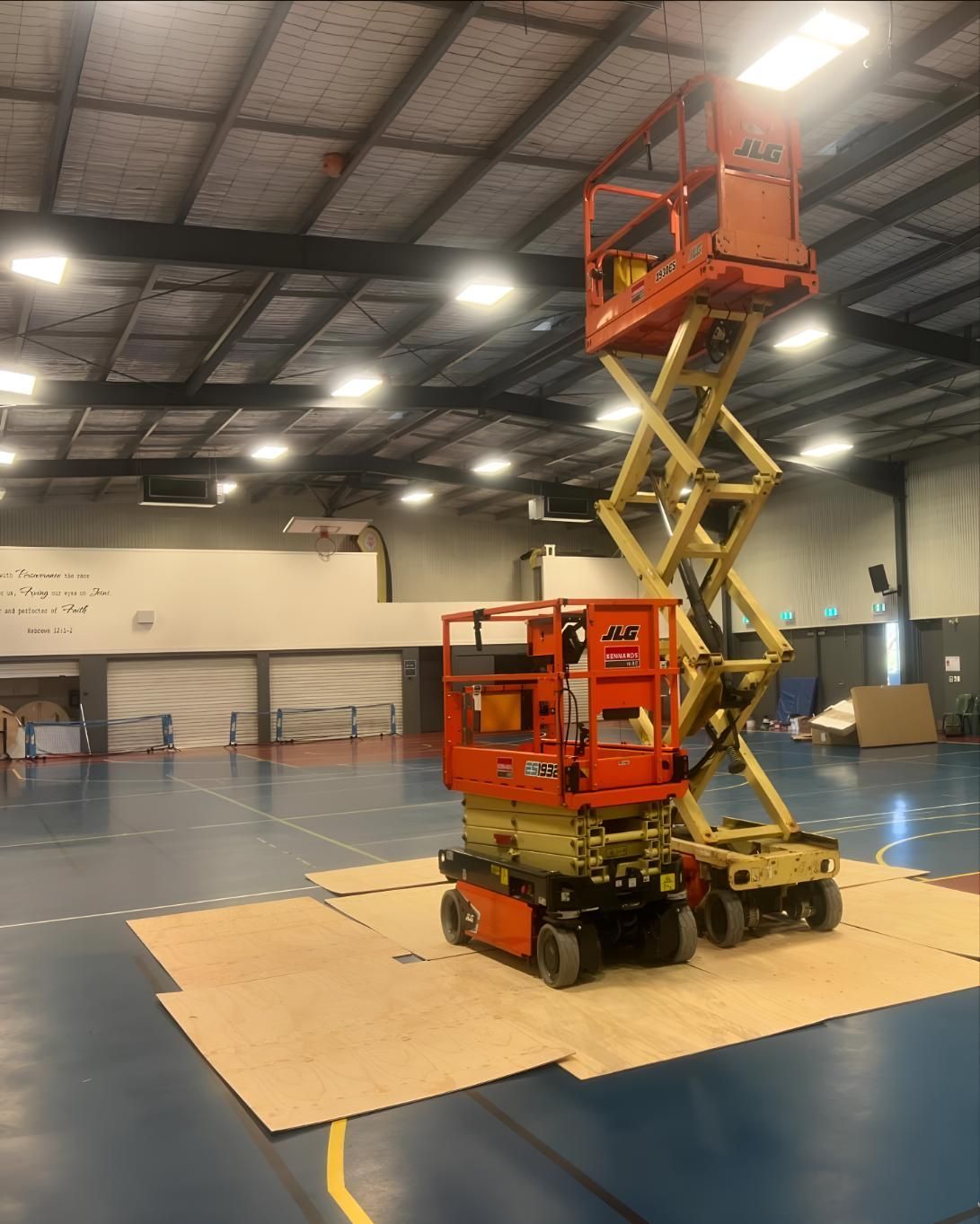 Scissor Lift is Sitting on Top of a Cardboard Box — Kiama Air Conditioning in Albion Park Rail, NSW