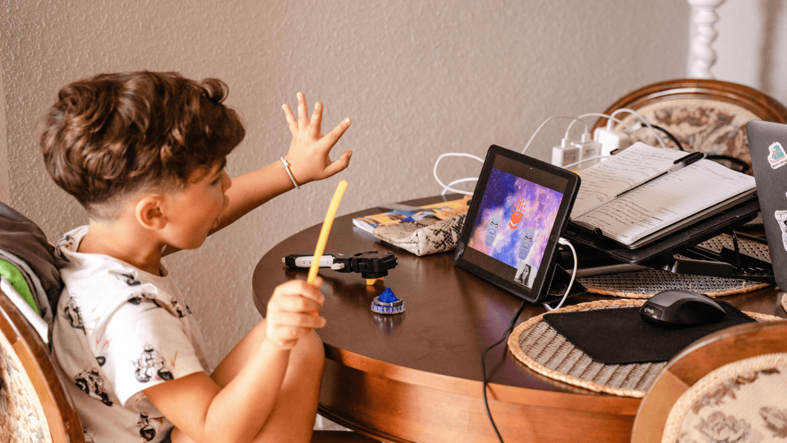 Young child at desk playing on Ipad