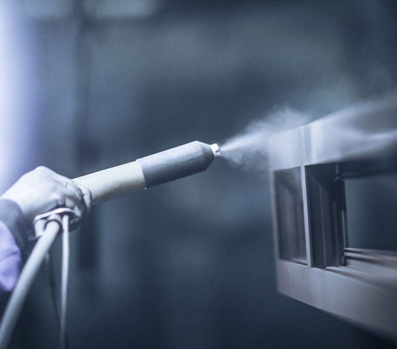 Worker Using Spray Gun — Powder coating service in Tomago, NSW