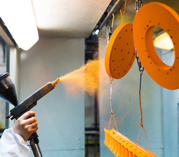 Powder Paint from a Gun on Metal Products — Powder coating service in Newcastle, NSW