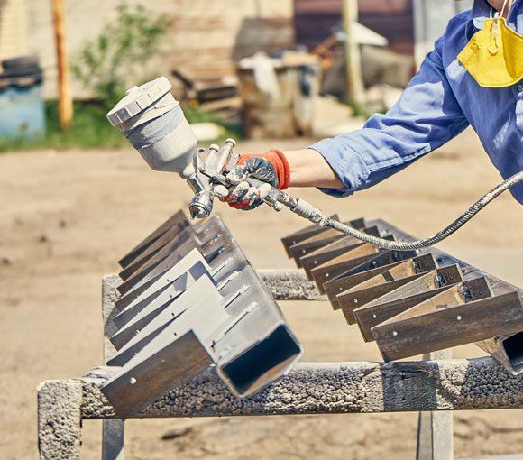 Man Spraying Metal — Powder coating service in Singleton, NSW