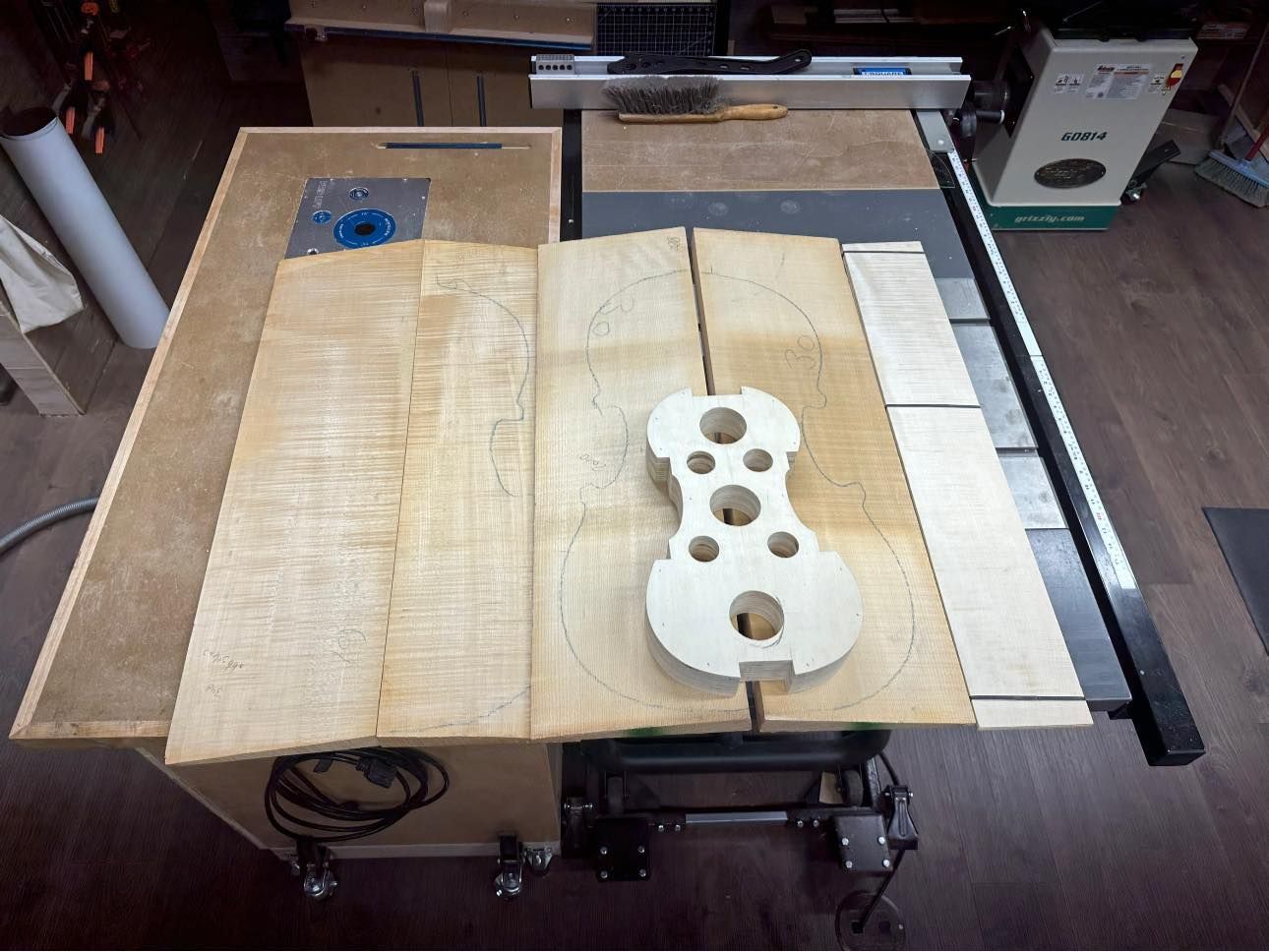A piece of wood is sitting on top of a table saw