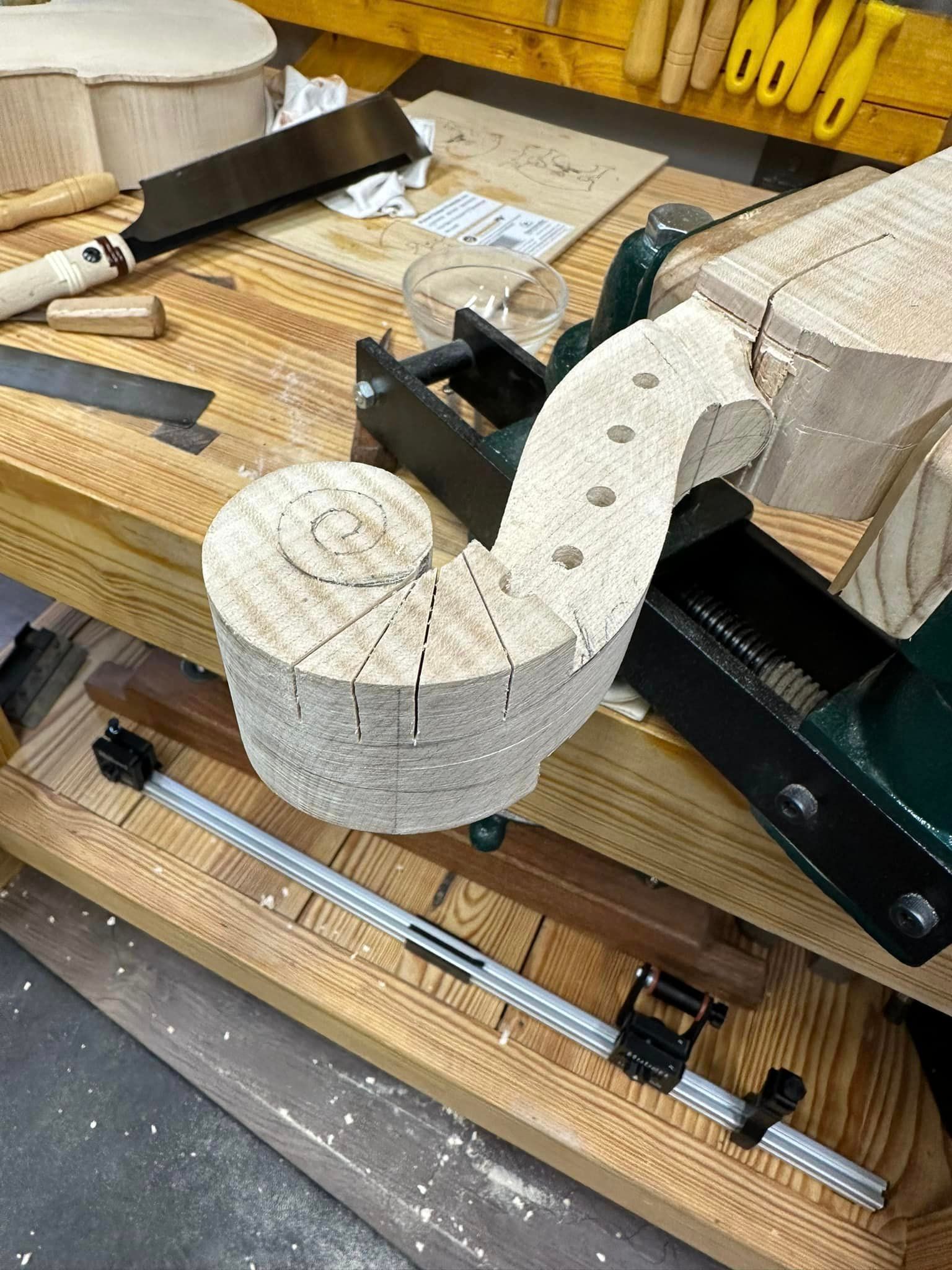 A piece of wood is sitting on top of a wooden workbench