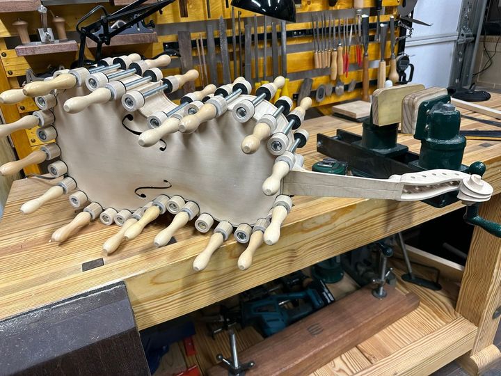 A piece of wood is sitting on top of a wooden workbench.