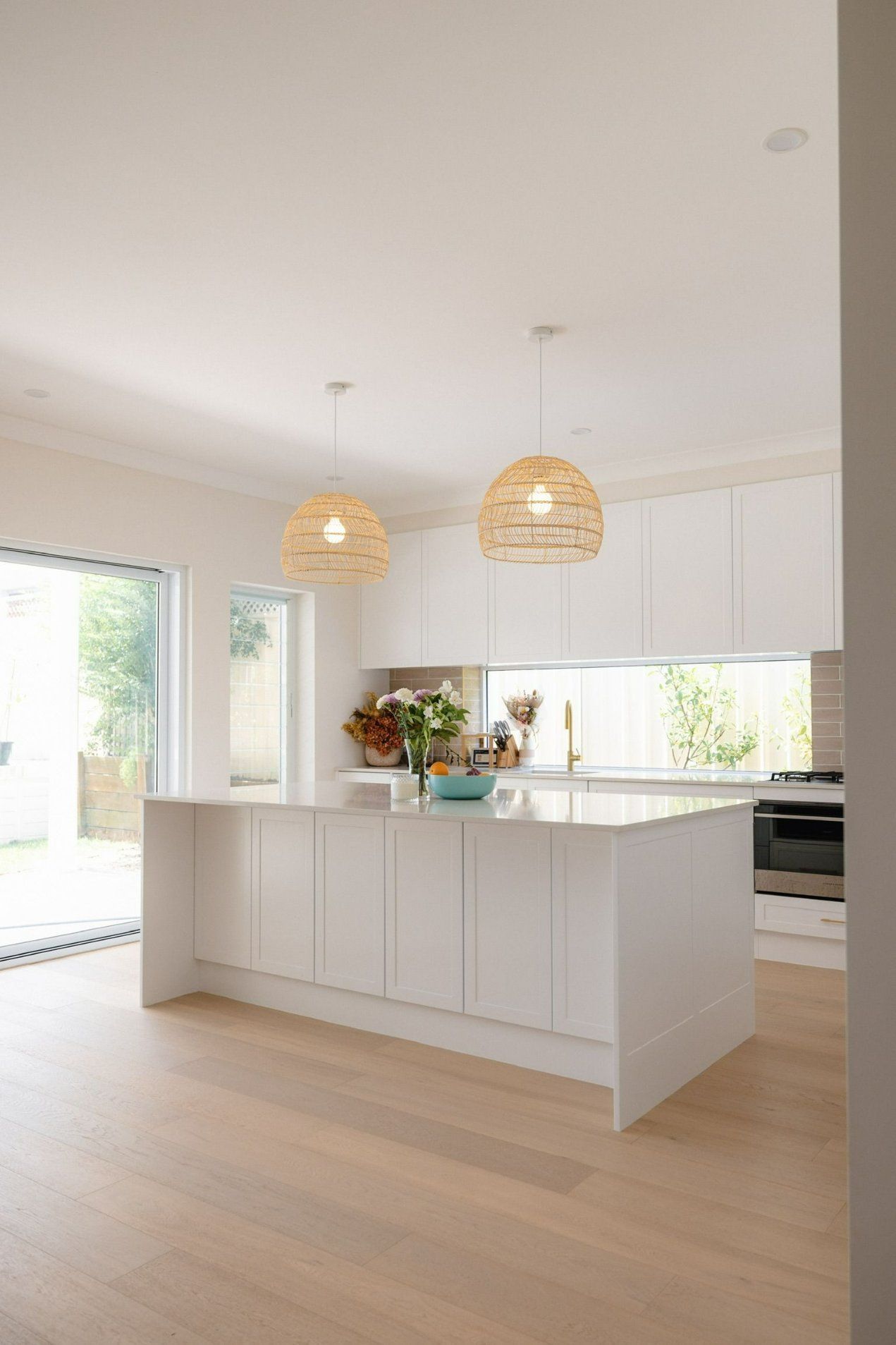 A Kitchen with white Cabinets and White Counter Tops — Blue Horizon Projects in Bateau Bay, NSW
