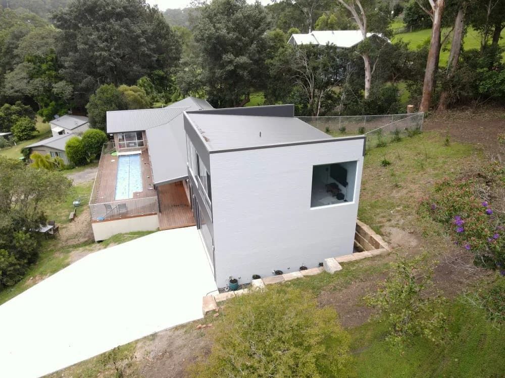 An Aerial View of A House with A Pool in The Backyard — Blue Horizon Projects in Bateau Bay, NSW