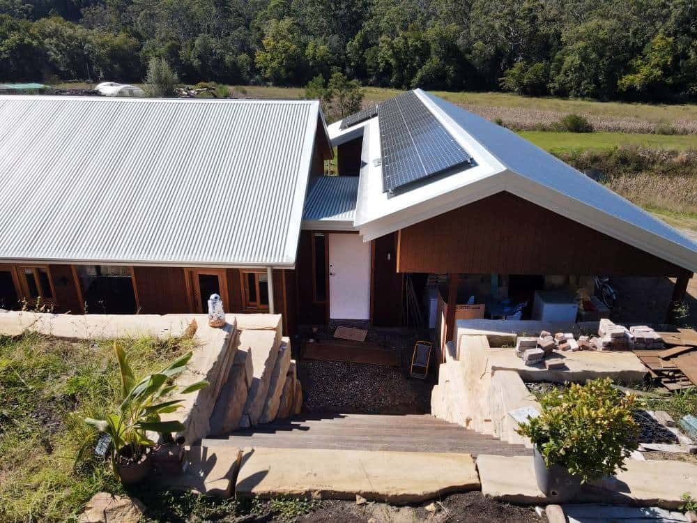 An Aerial View of A House with Solar Panels on The Roof — Blue Horizon Projects in Bateau Bay, NSW