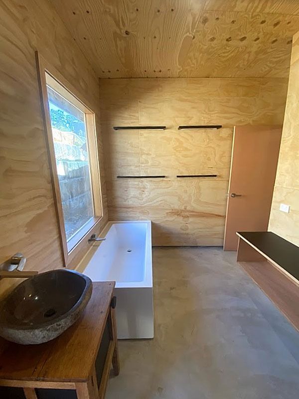 A Bathroom with A Bathtub, Sink and Window — Blue Horizon Projects in Bateau Bay, NSW