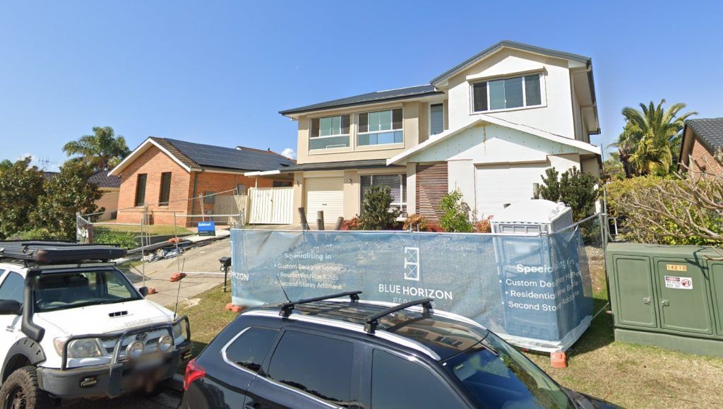 A Car Is Parked in Front of A House Under Construction — Blue Horizon Projects in Bateau Bay, NSW