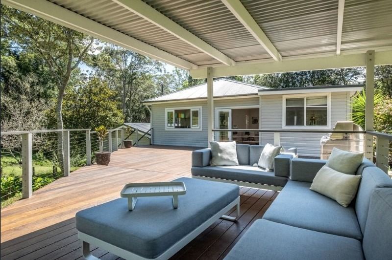 A Deck with A Couch and A Table on It — Blue Horizon Projects in Bateau Bay, NSW