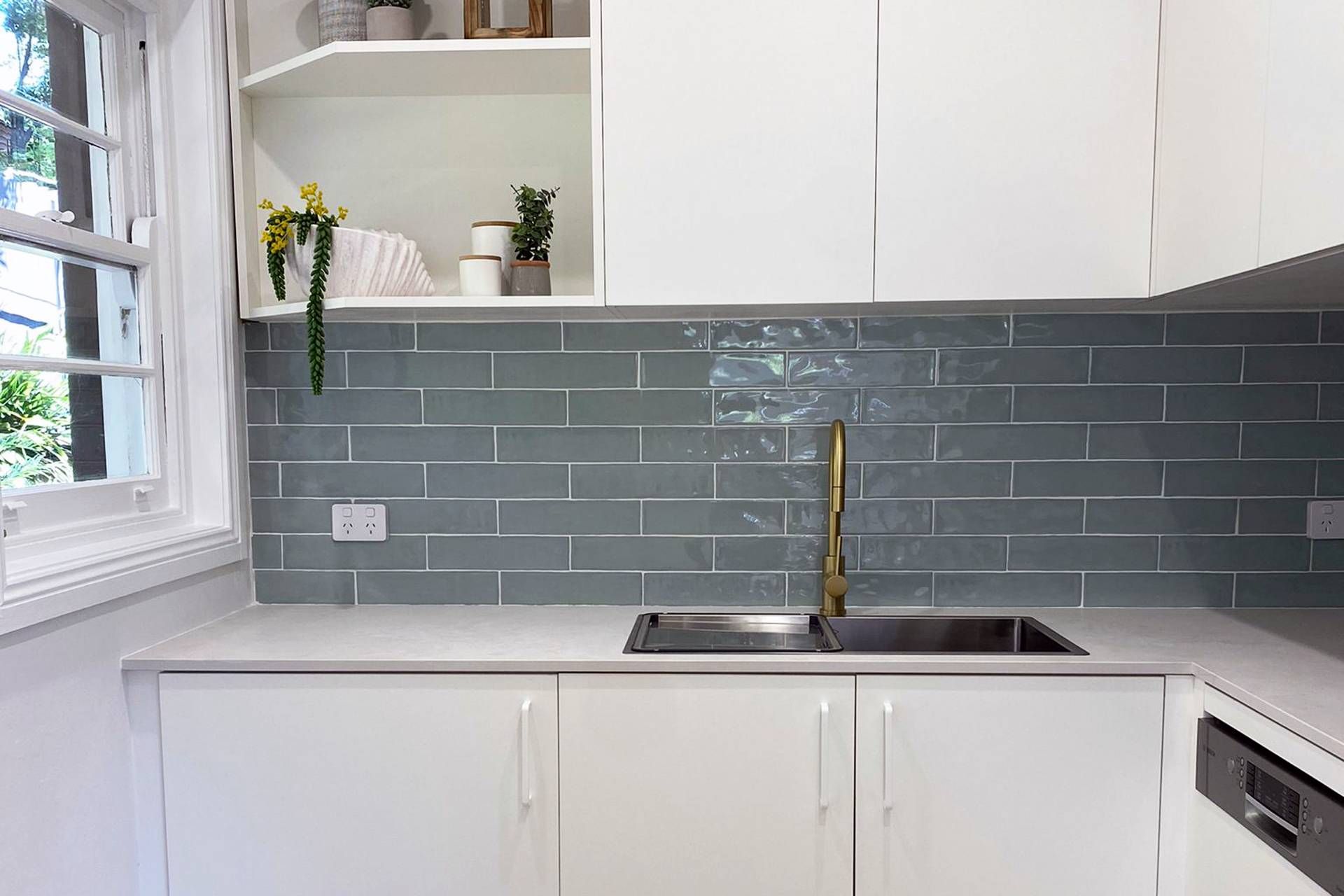 A Kitchen with White Cabinets, a Sink, and A Window — Blue Horizon Projects in Bateau Bay, NSW