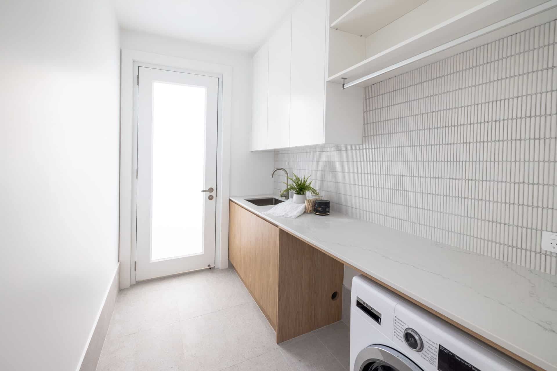 A Laundry Room with A Washing Machine and A Sink — Blue Horizon Projects in Bateau Bay, NSW