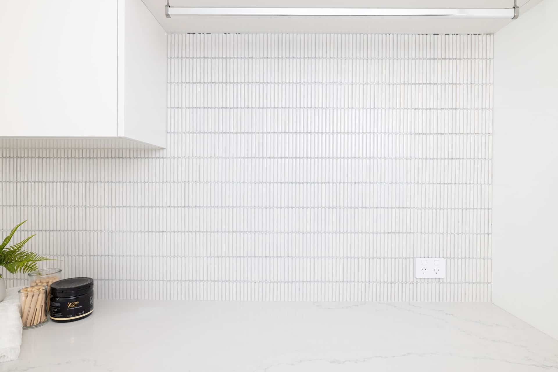 A Laundry Room with White Tiles and A Clothesline — Blue Horizon Projects in Bateau Bay, NSW