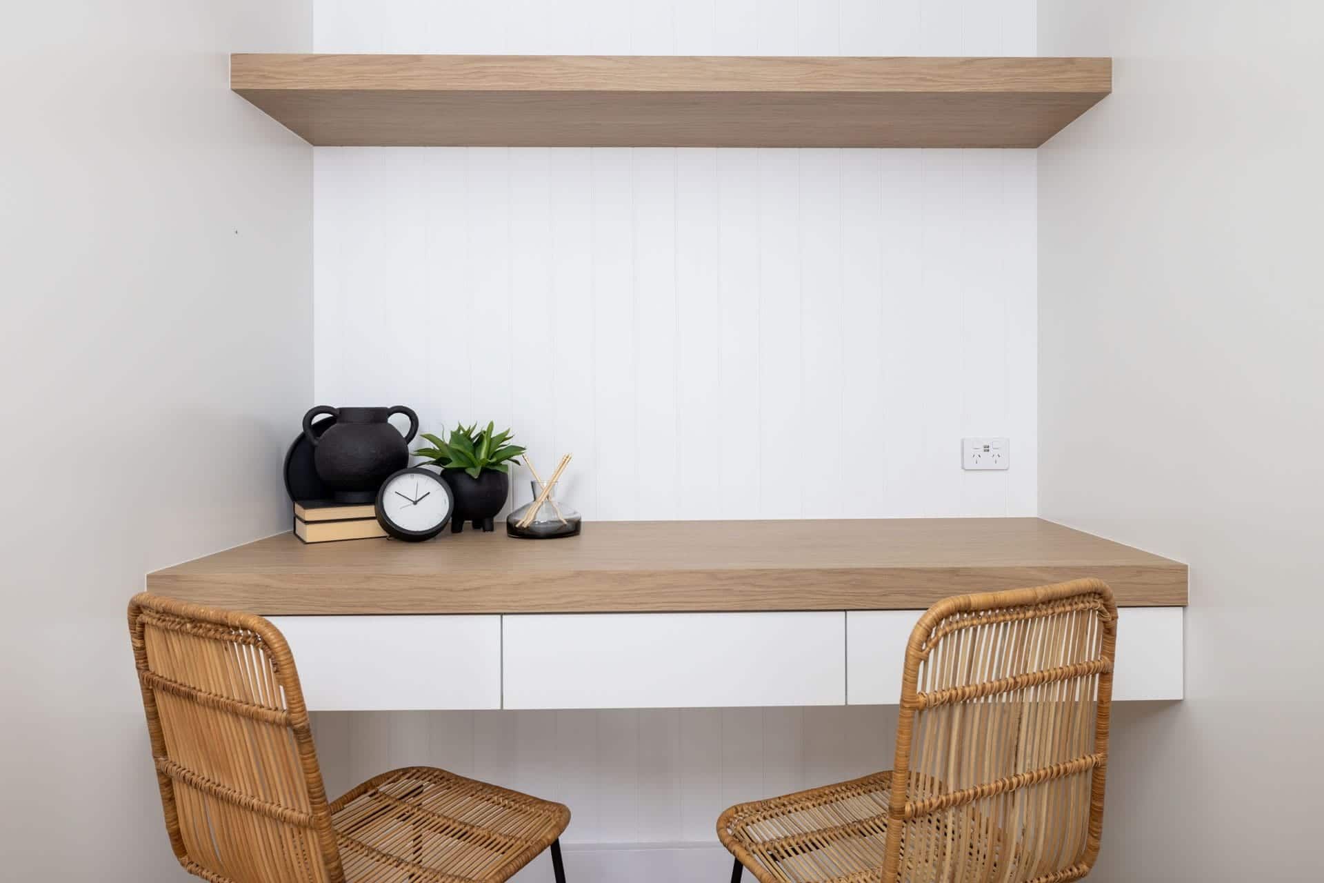 There Is a Desk with Two Chairs and A Clock on It — Blue Horizon Projects in Bateau Bay, NSW