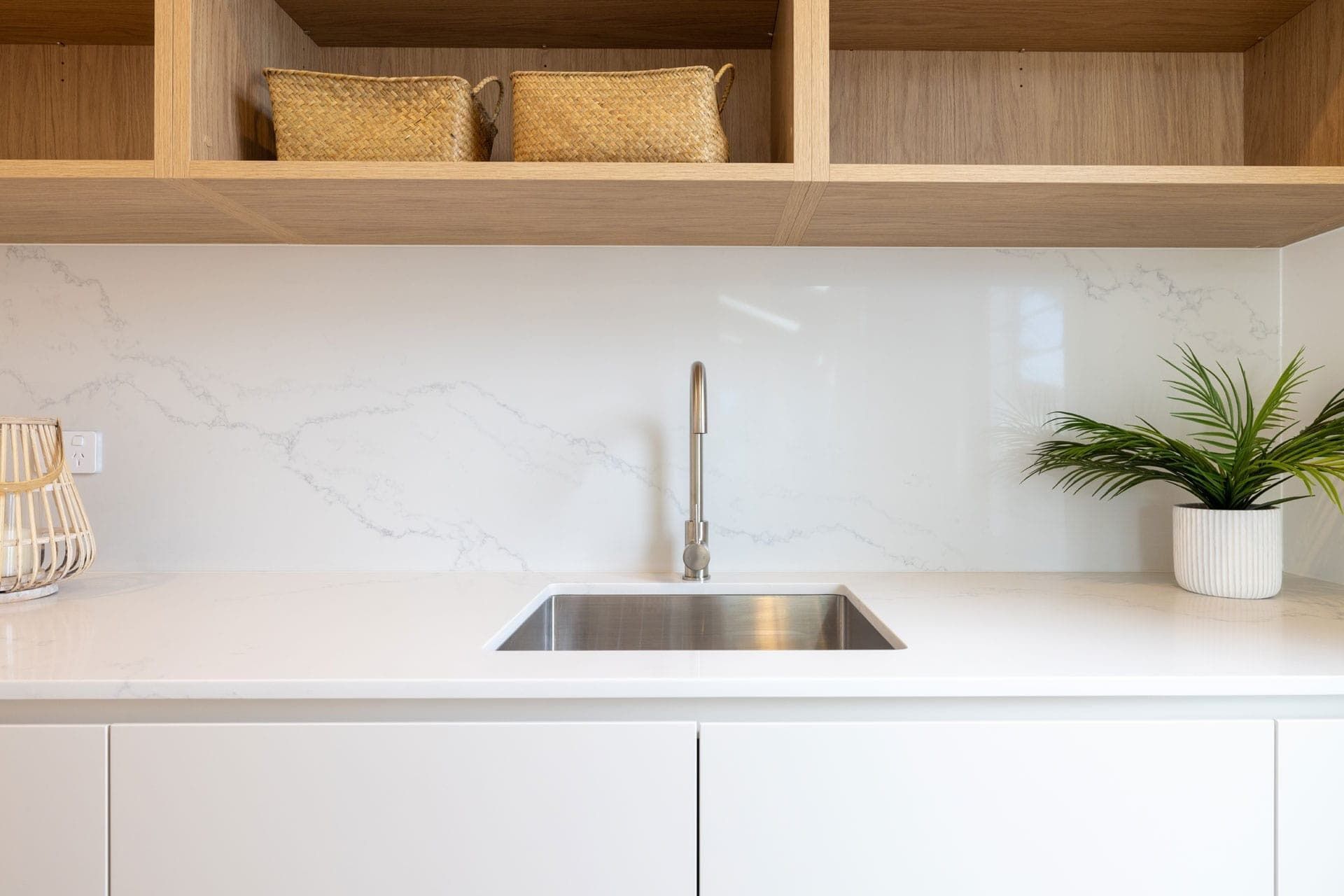 A Kitchen with A Sink and A Plant on The Counter — Blue Horizon Projects in Bateau Bay, NSW