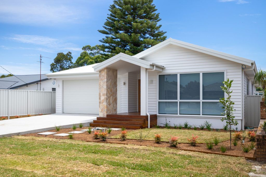 A Car Is Parked in Front of A House Under Construction — Blue Horizon Projects in Bateau Bay, NSW