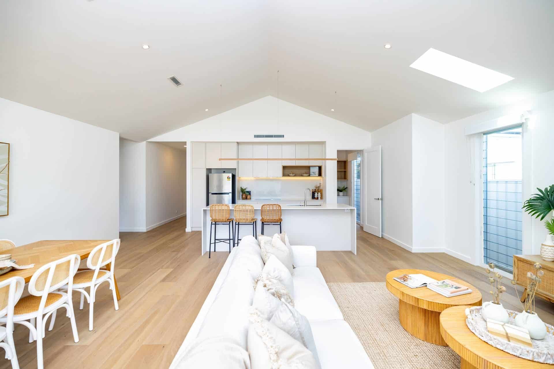 Bright, Modern Open-Plan Living Space Featuring a White Couch — Blue Horizon Projects in Bateau Bay, NSW