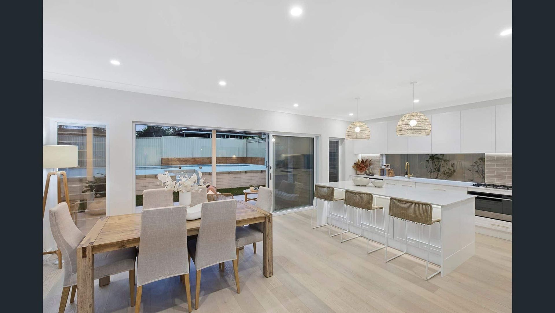 Modern Open-Plan Kitchen and Dining Area with Light Wood Floors — Blue Horizon Projects in Bateau Bay, NSW